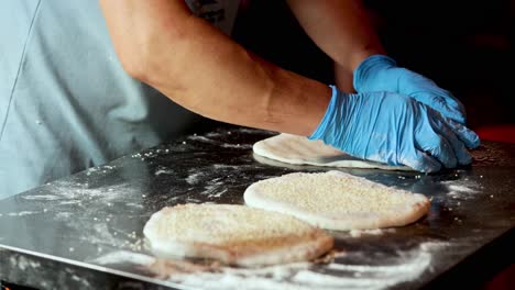 baker shaping dough with precision and care