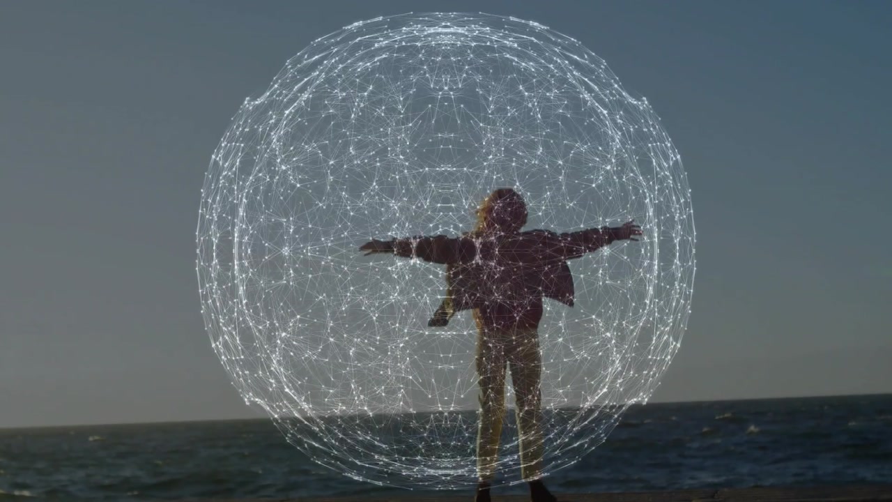 Woman standing on seawall with arms extended, sphere appearing then forming tech halo framing her
