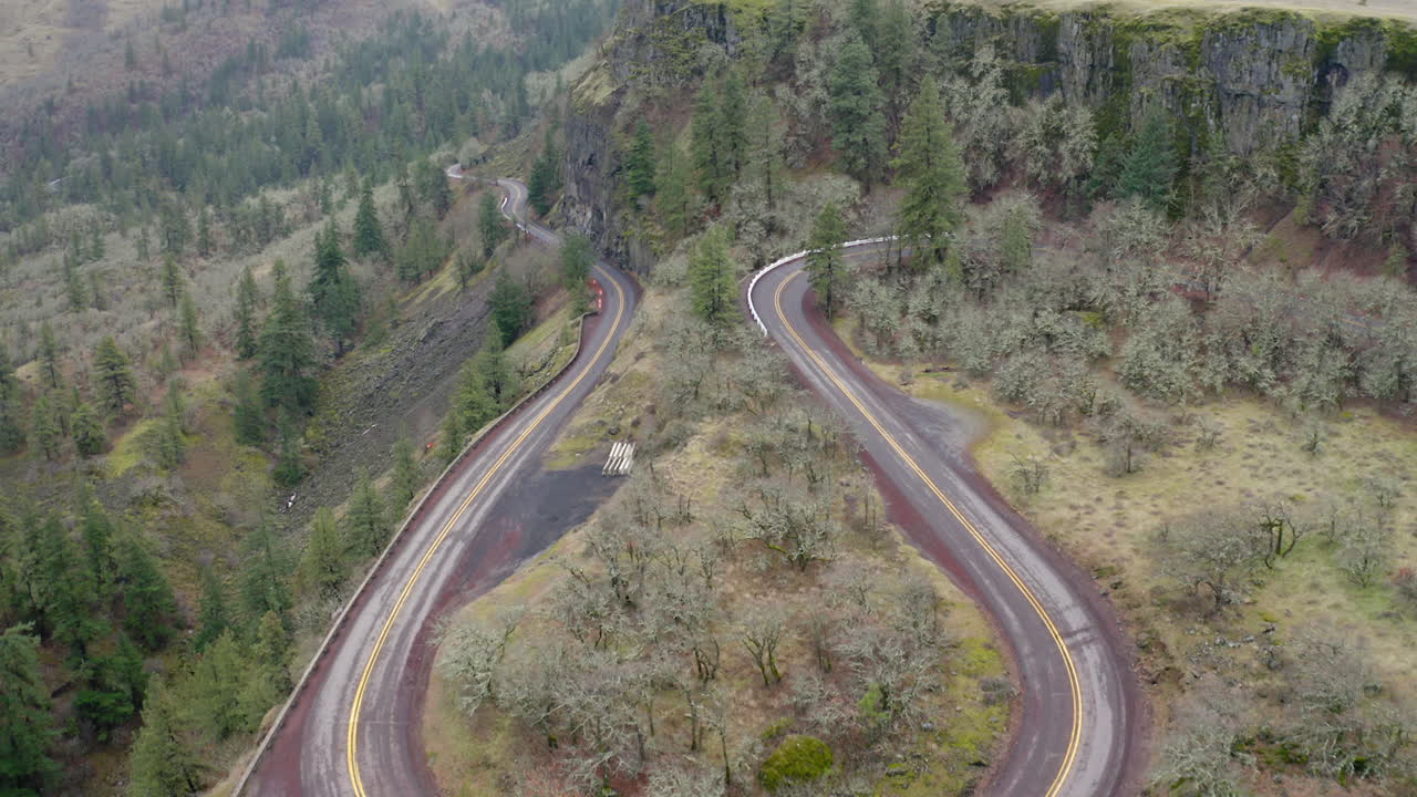 Aerial View of Scenic Winding Roads in a Mountainous Forest Landscape