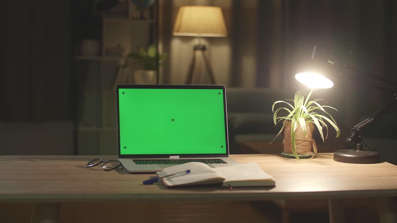 Laptop Computer Showing Green Chroma Key Screen Stands On A Desk In The Living Room