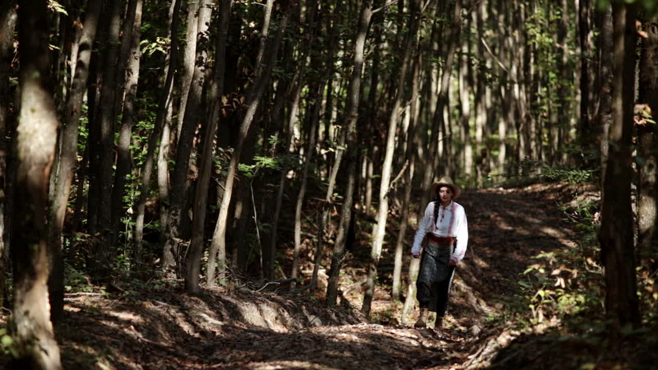 Romanian girl walks through the forest and admires nature 3
