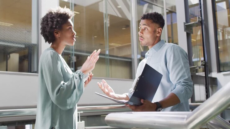 Video of diverse businessman and businesswoman talking in office