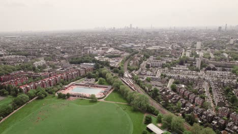 london city aerial view from parliament hill flying by around belsize park, kentish town, chalk farm, camden town suburban neighborhood cityscape in england, uk