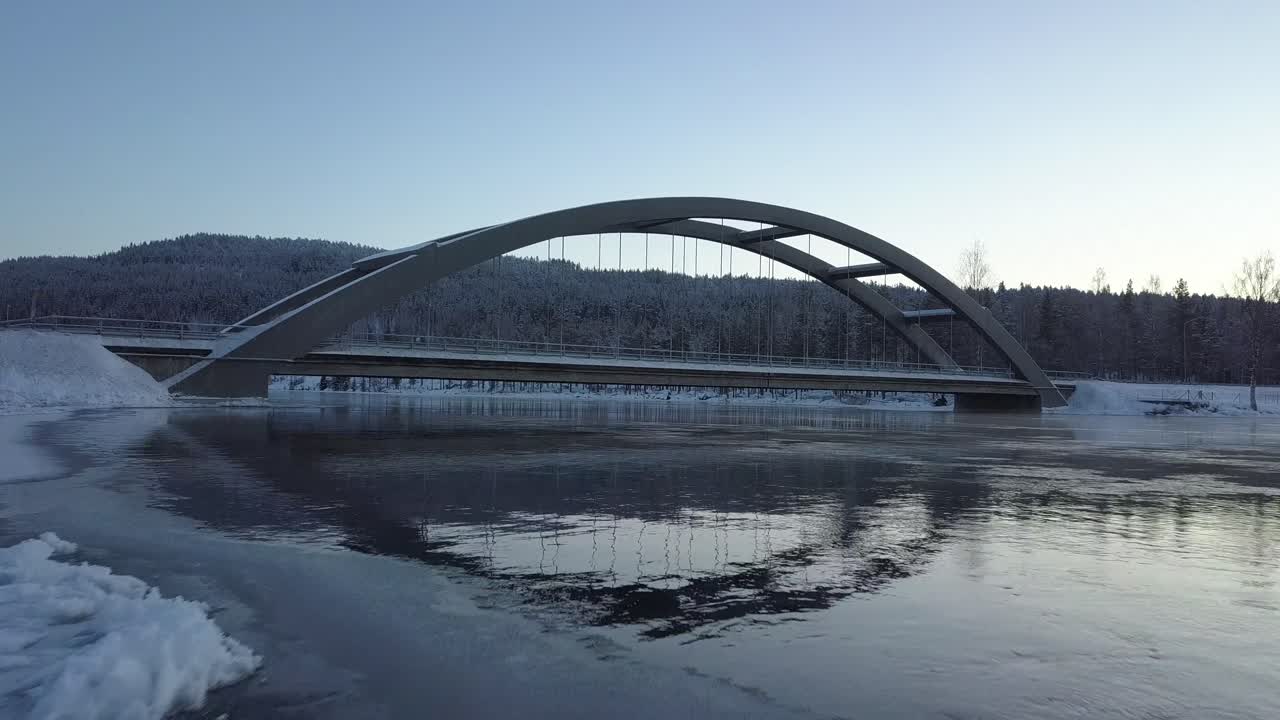 A bridge in a rural frozen landscape of Sweden, during winter