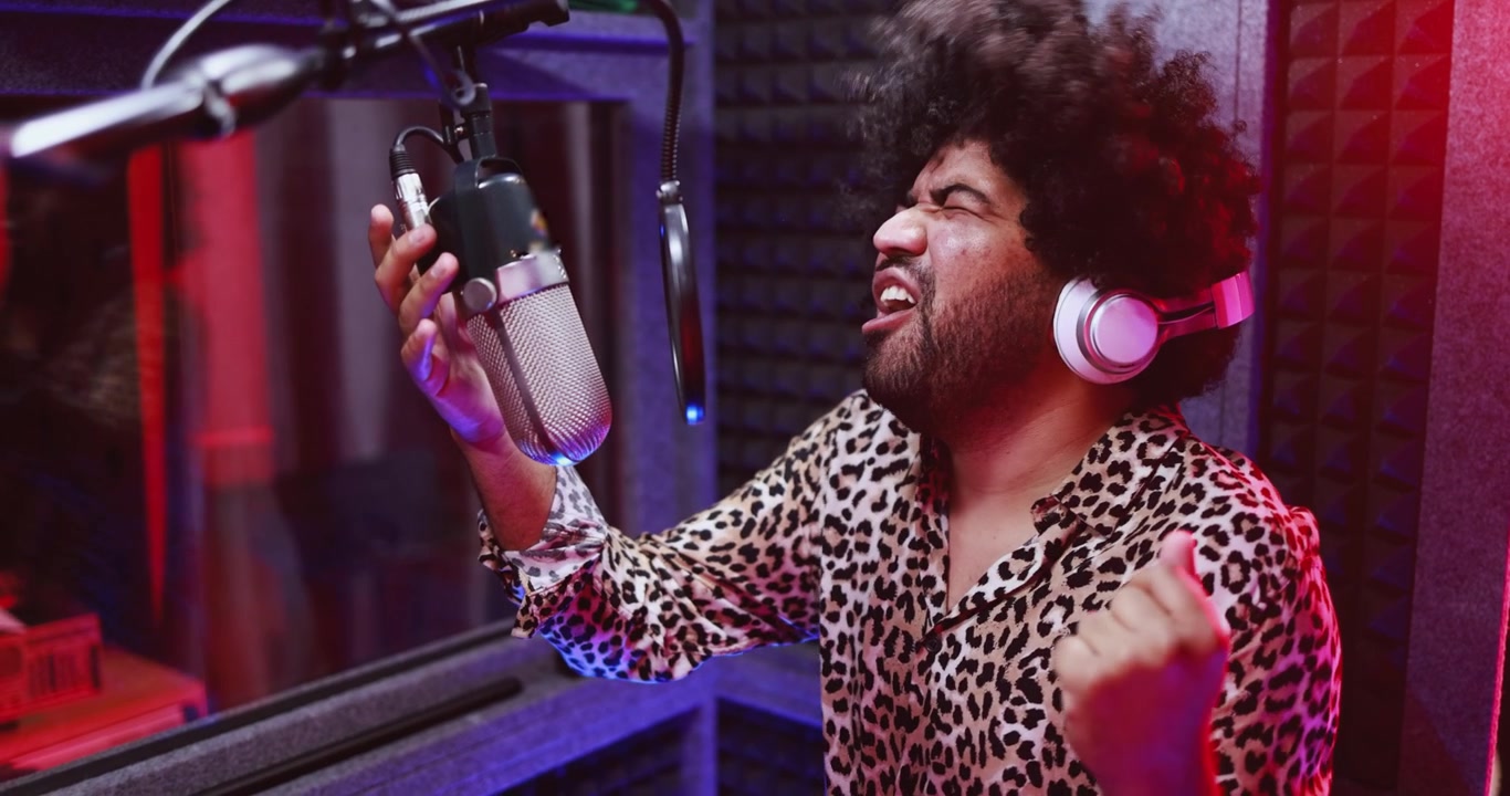 Passionate Man Singing into Microphone in Professional Recording Studio