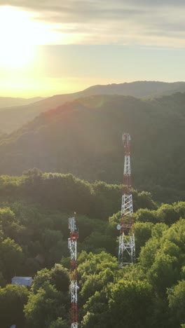 sunset over mountain landscape with communication towers