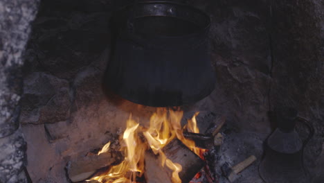 vintage steel pot over wooden oven stove