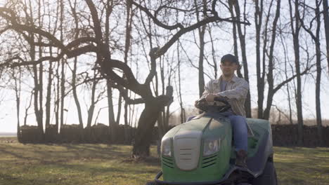 caucasian man with plaid shirt driving a quad in the countryside