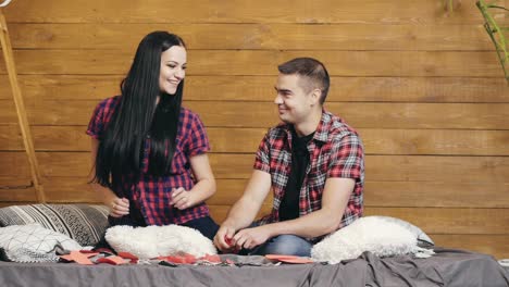 modern couple dancing and having fun. smiling young couple dancing on bed at studio