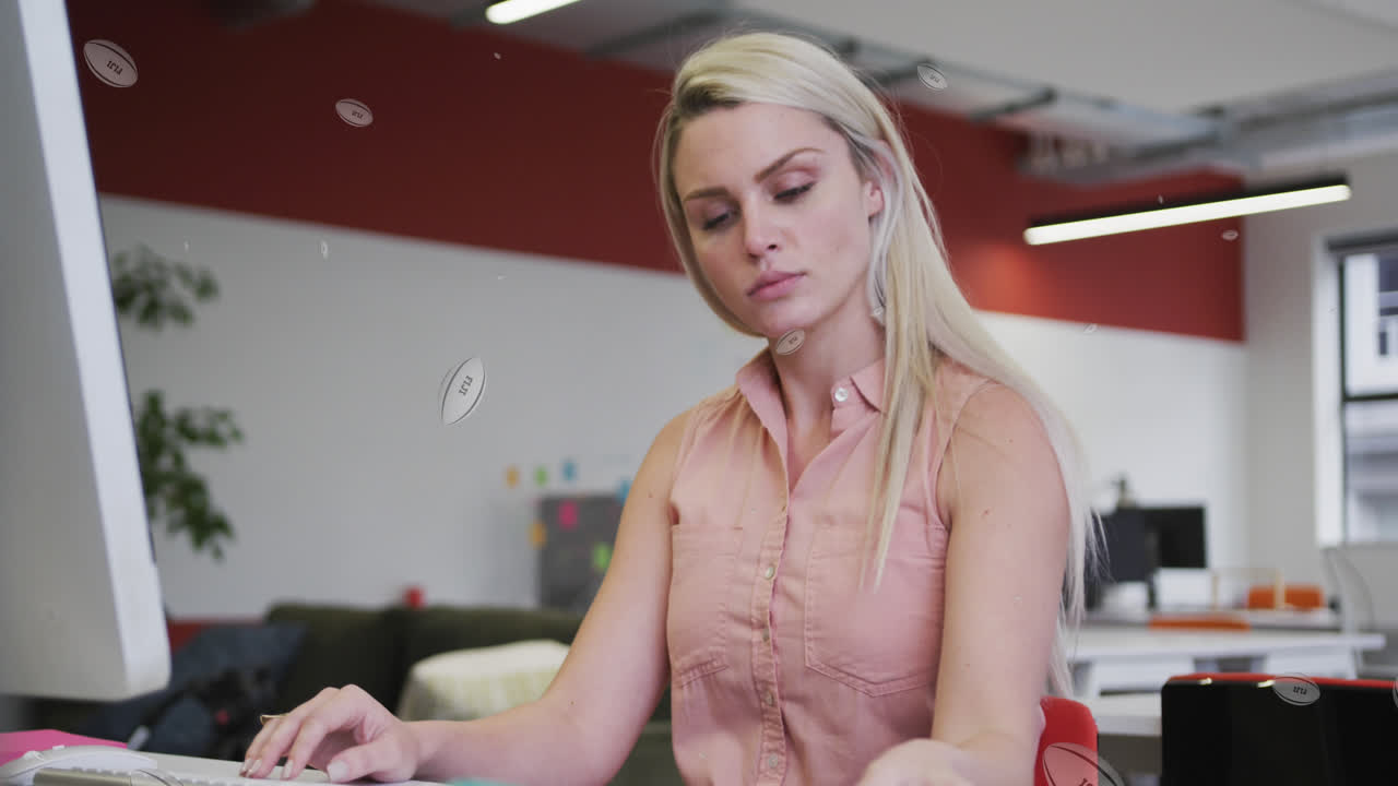 Animation of rugby balls with fiji text over caucasian businesswoman thinking