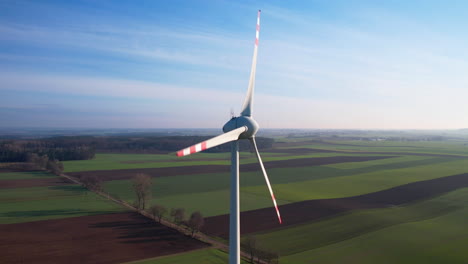 Aerial-View-Of-Spinning-Blades-Of-Giant-Wind-Turbine-In-Rural-Countryside