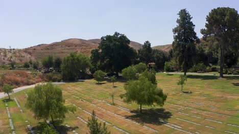 Slow-aerial-shot-flying-over-rows-of-headstones-at-a-mortuary-in-California