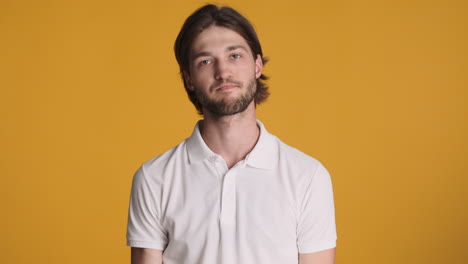 caucasian man in front of camera on yellow background.