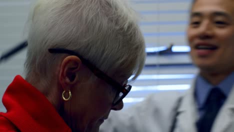 close-up of young asian male doctor examining a senior patient with otoscope in the clinic 4k