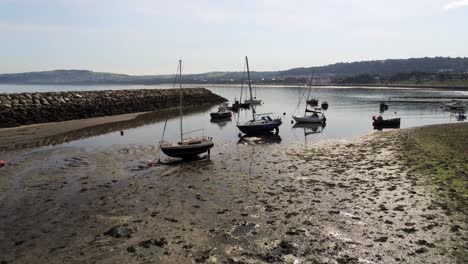 Aerial-view-boats-in-shimmering-low-tide-sunny-warm-Rhos-on-Sea-seaside-sand-beach-marina-low-push-in