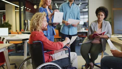 Happy-disabled-and-diverse-business-people-discussing-work-at-office