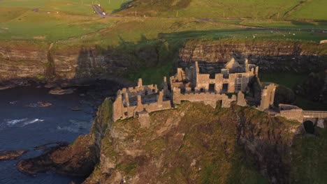 Aerial-view-of-Dunluce-Castle-on-a-sunny-evening,-County-Antrim,-Northern-Ireland