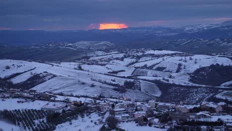 sunset view of snow covered hills and villages from guardiagrele, abruzzo, italy