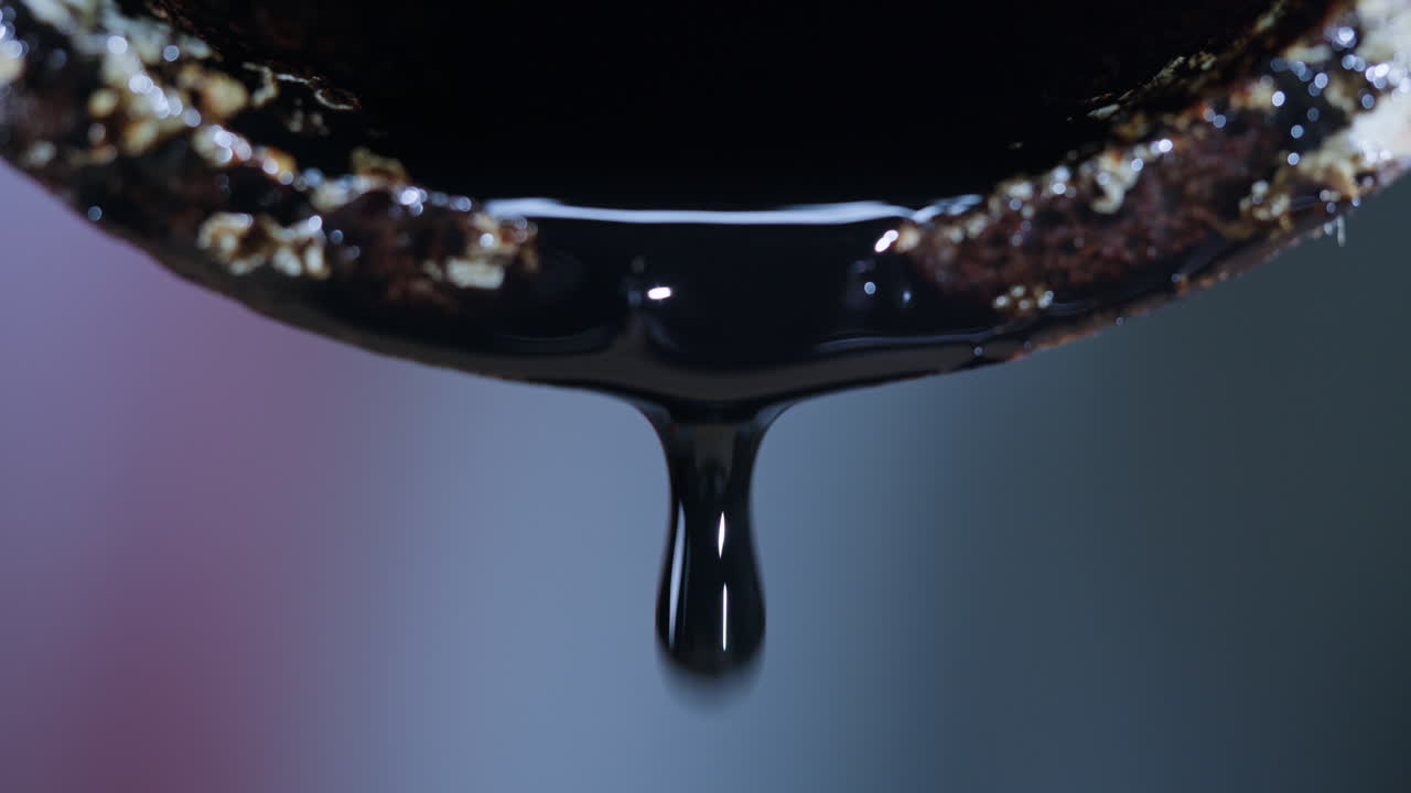 Close-up of oil dripping from a rusty pipe