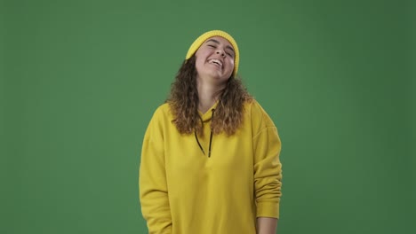 woman laughing over green background