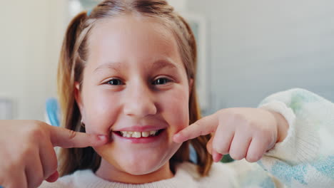 a smiling girl showing her teeth