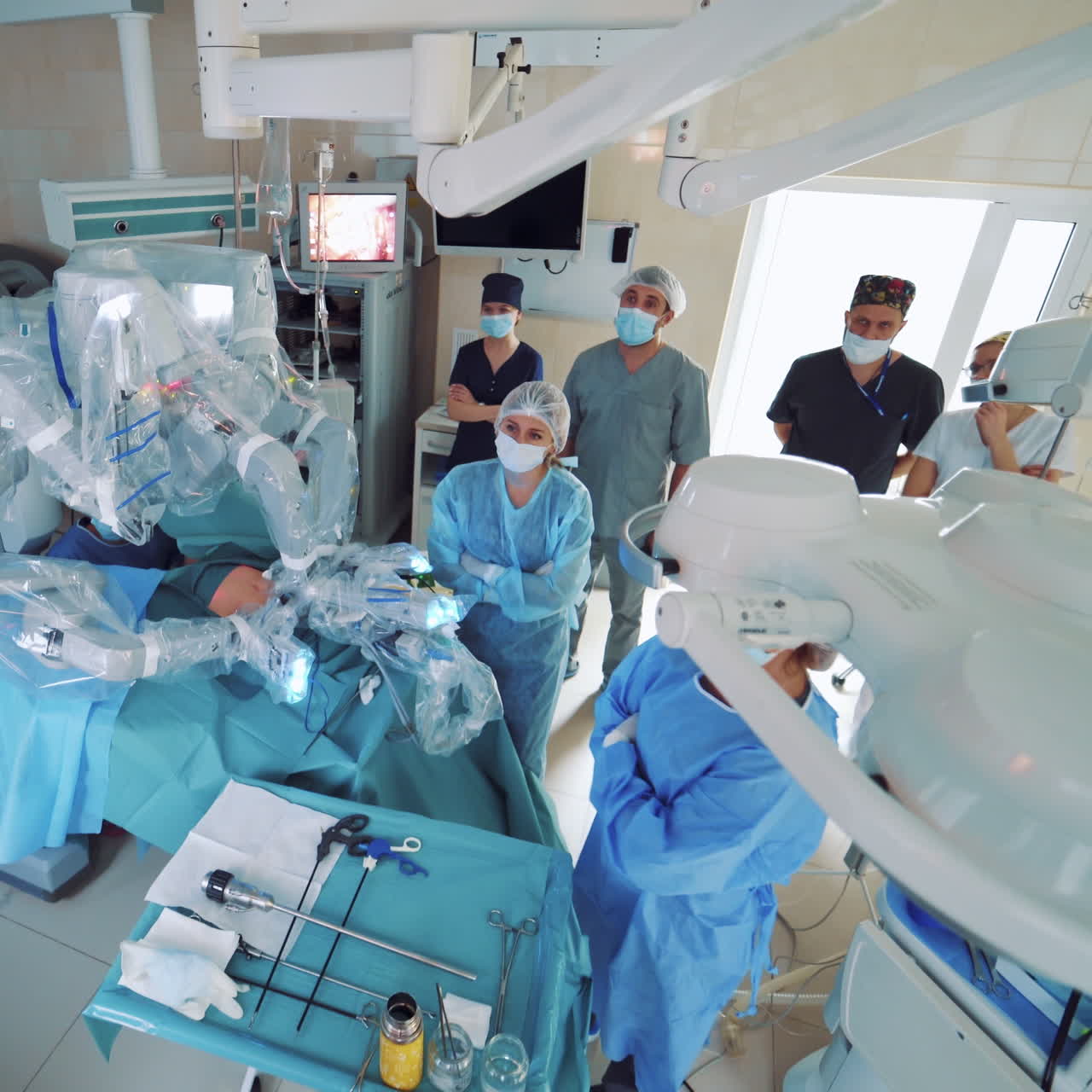 Medical surgical robot, cancerous tumor removal surgery. Modern medical equipment. Minimally Invasive Robotic Surgery System. Monitor shows procedure in background