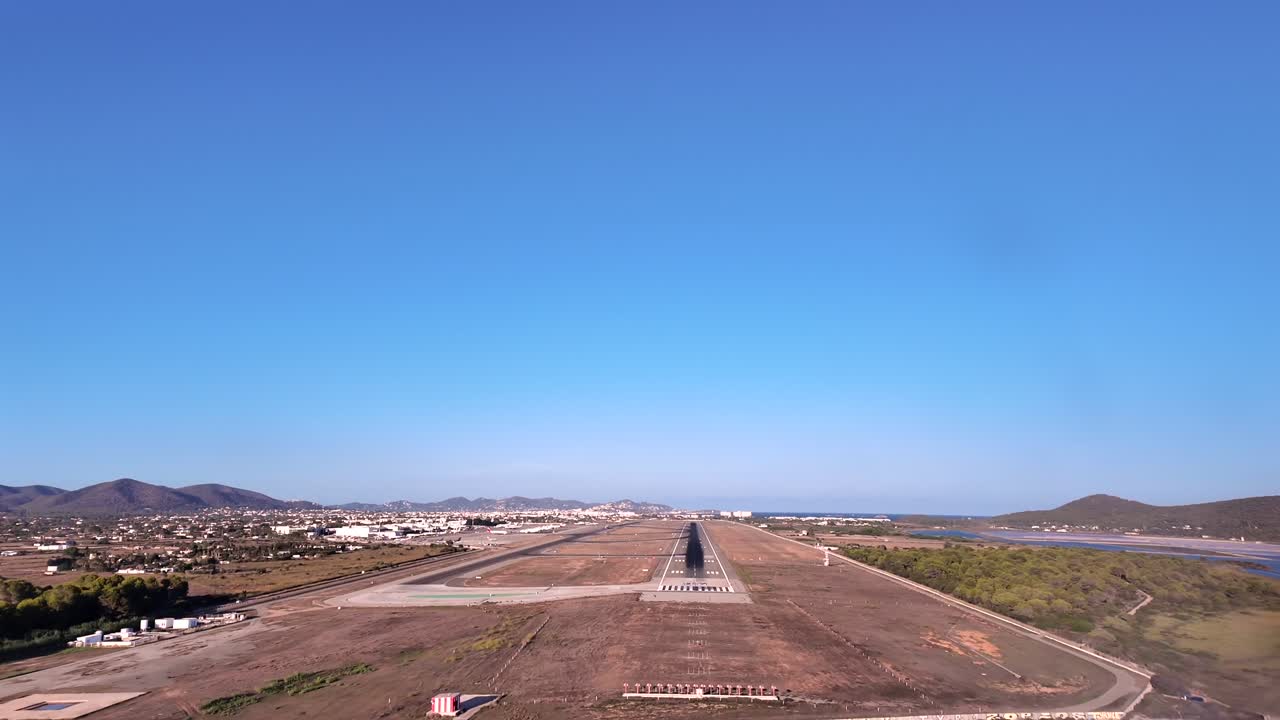 An immersive landing experience through the pilot’s eyes in the short final mapproach to Ibiza’s airport runway, overflying the coastline at very low altitude, in a summer afternoon. ultra-realistic