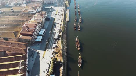 4k-aerial-drone-footage-of-ships-anchored-along-the-bank-of-a-river-channel-in-coastal-city-of-Porto-in-northwest-Portugal