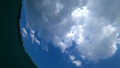 view of the sky and clouds from under the water.