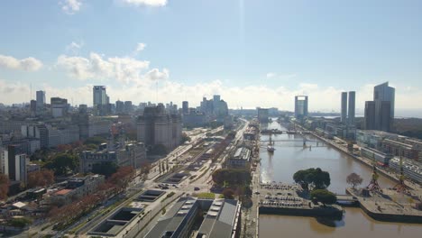 Aerial-view-passing-over-a-wateway-revealing-Paseo-del-bajo-highway-at-Buenos-Aires-city