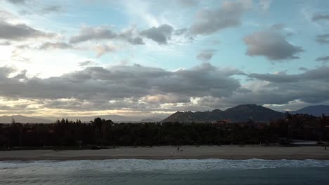 Aerial-Tracking-Right-along-the-shore-at-sunset