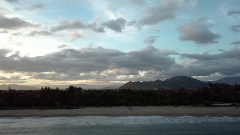 aerial tracking right along the shore at sunset