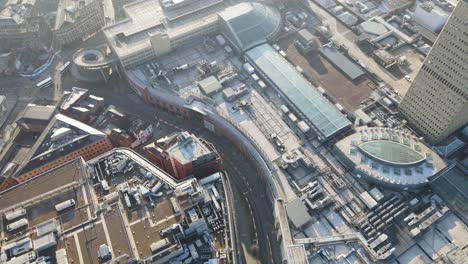 4k 60fps aerial drone flight passing over the printworks in manchester city centre with a birdseye view of rooftops at the arndale centre