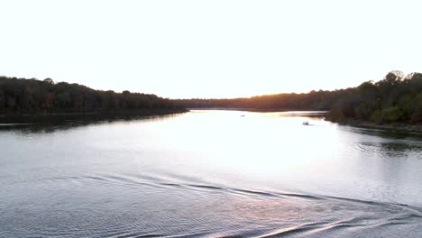 Dolly-Forward-over-a-Boat-on-a-Lake-Towards-the-Sunset