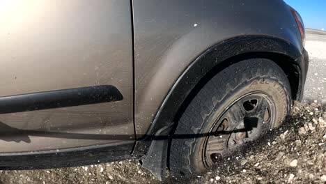 close up of suv breaking through muddy playa mud and dirt epic offroading