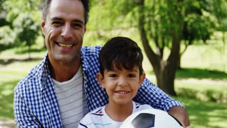 Father-and-son-sitting-in-the-park