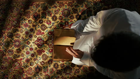 man praying on carpet for ramadan
