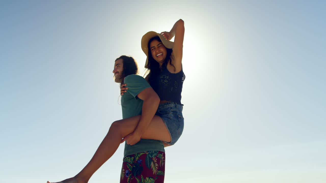 Man giving a piggyback ride to woman 4k