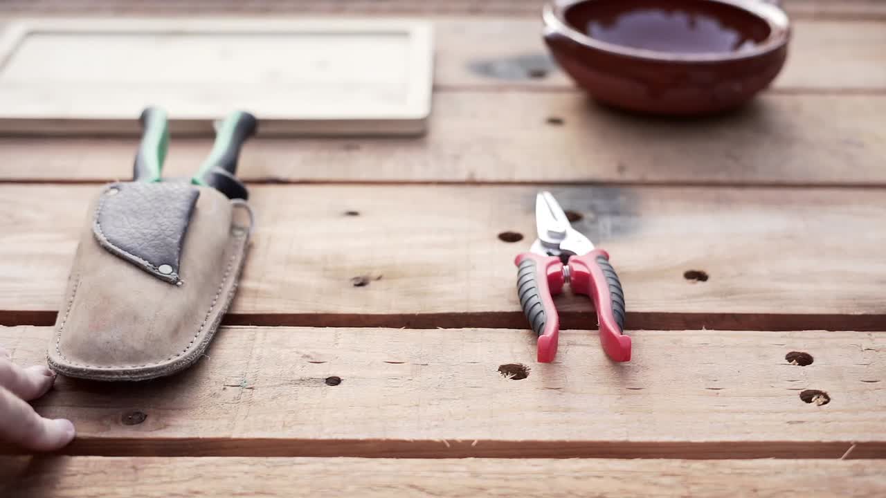 Garden tools and a man in a garden