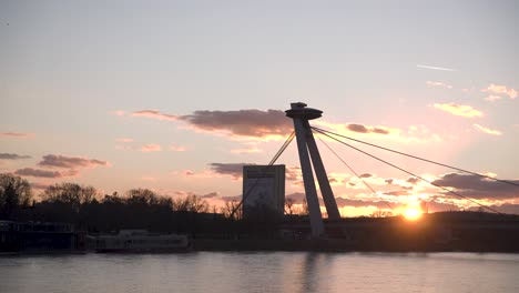 ufo tower bridge over danube river in bratislava at sunset, slovakia
