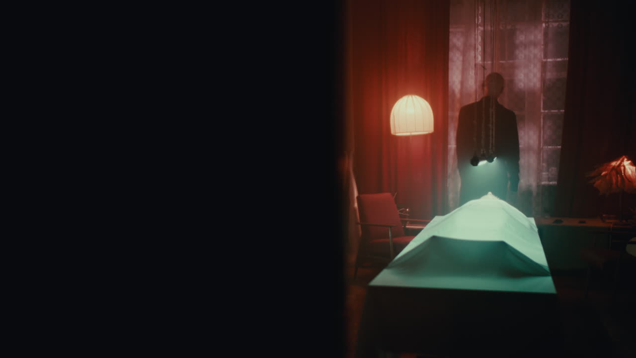 A Man Examining a Body in a Dark Room