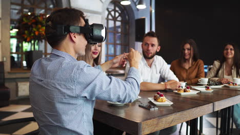 Team-of-developers-working-with-virtual-reality-glasses-during-a-business-meeting.-Young-business-colleagues-brainstorming-using-VR-goggles