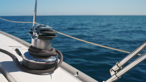 close up of winch and coiled rope on sailboat moving over south pacific ocean