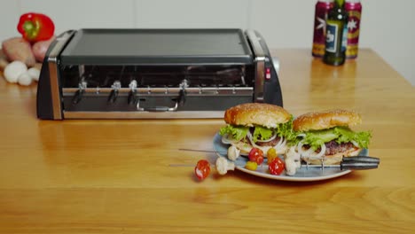 appetizing burgers and skewers grilled on plancha grill, presented on plate. tilt up pan