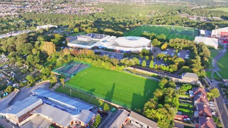 drone descend across empty soccer field with cleanly cut grass, barnsley england