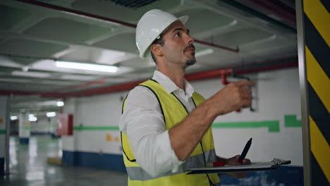 serious inspector writing paper working underground closeup. expert man checking
