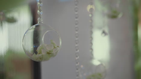 decorative element of glass ball with dry flower petals