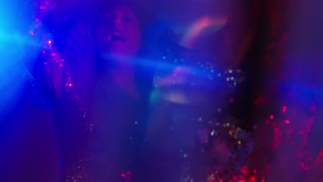 close up of two women in nightclub bar or disco dancing with sparkling lights 5