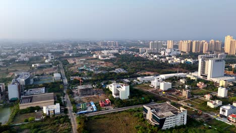 aerial view of chennai's expanding urban landscape, omr (old mahabalipuram road). features mixed development, active construction, and a skyline of numerous high-rise towers.