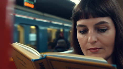 woman reading a book on the subway